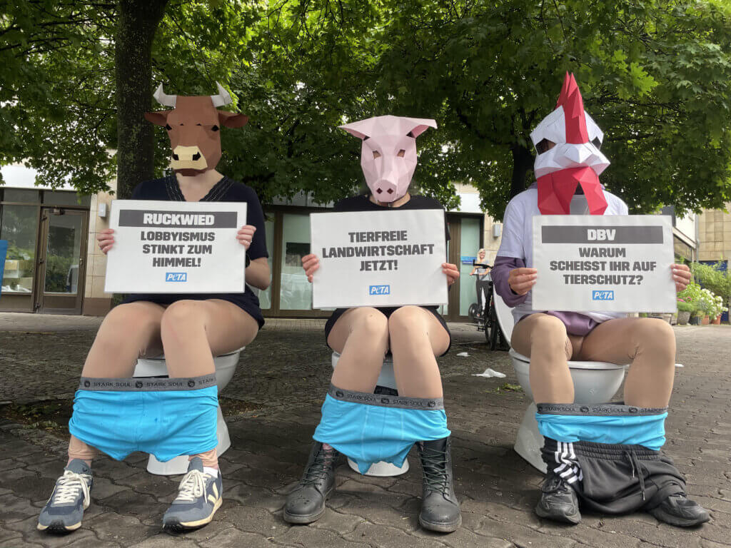 Aktivisten sitzen auf Klo und demonstrieren gegen den Bauerntag in Berlin 2025